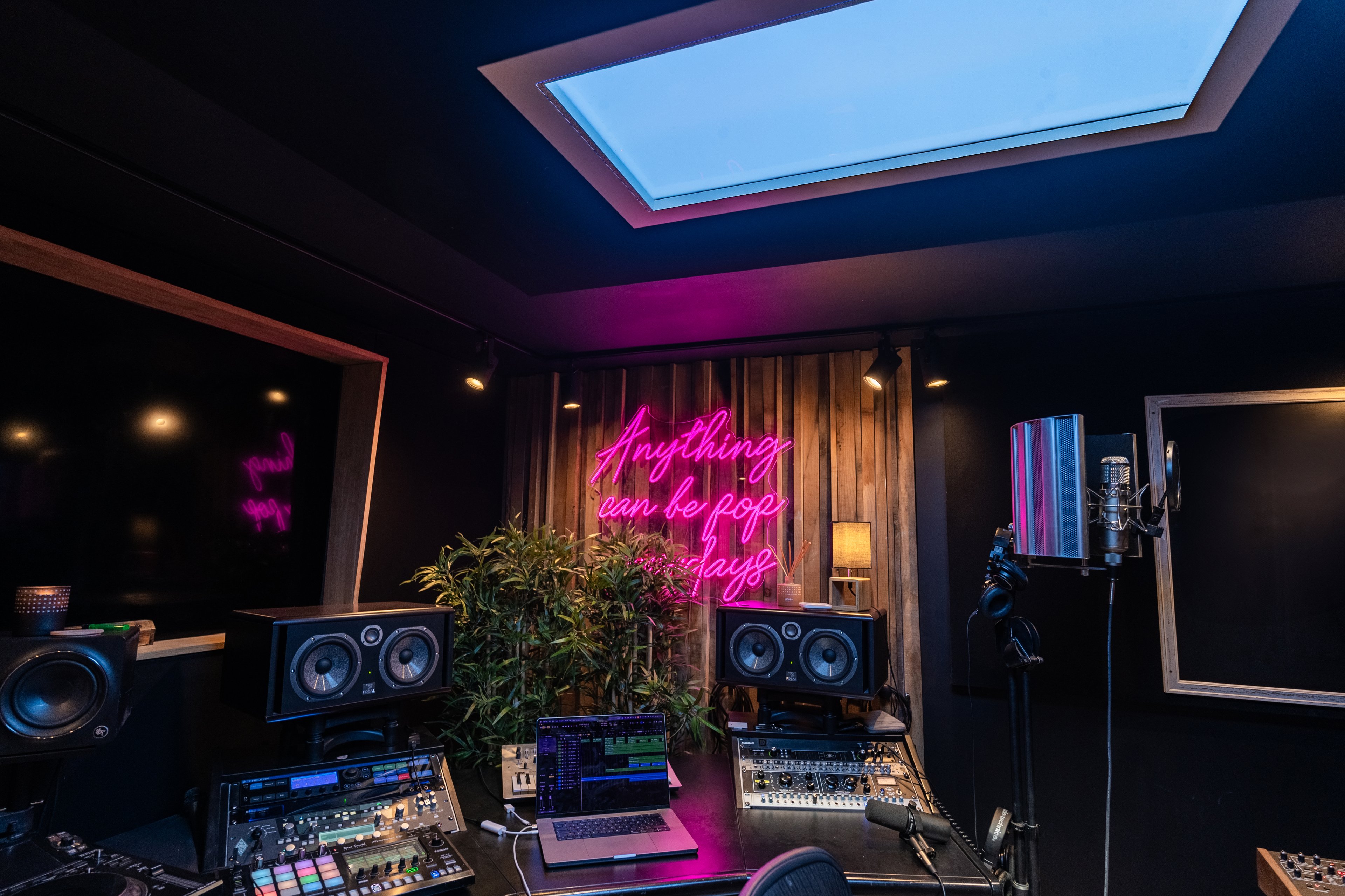 Innerscene Virtual Sun installation case study in John Newman studio with a pink neon sign and music production equipment